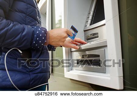 "Young woman using cash machine, mid section" View Large Photo Image Stock Photograph - "Young woman using cash machine, mid section". Fotosearch
