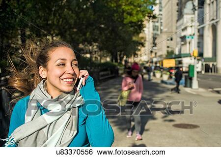 Young woman using smartphone in park View Large Photo Image Stock Photograph - Young woman using smartphone in park. Fotosearch