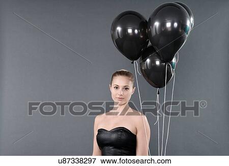 Young woman with black balloons, grey background View Large Photo Image Stock Photo - Young woman with black balloons, grey background. Fotosearch