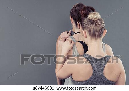Young women in a line, holding shoulders, grey background View Large Photo Image Stock Photography - Young women in a line, holding shoulders, grey background. Fotosearch