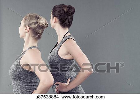 Young women practising yoga, grey background View Large Photo Image Picture - Young women practising yoga, grey background. Fotosearch