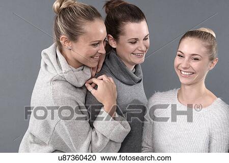 Young women smiling, grey background View Large Photo Image Stock Image - Young women smiling, grey background. Fotosearch