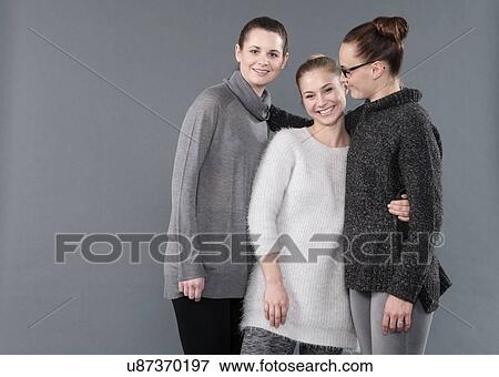 Stock Photo - Young women smiling, grey background. Fotosearch