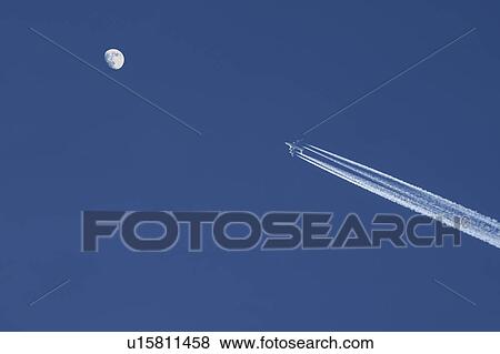 Airplane against blue sky with moon View Large Photo Image Stock Photo - Airplane against blue sky with moon. Fotosearch