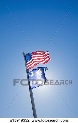 Stock Image - American and South Carolina State flags against clear sky. Fotosearch