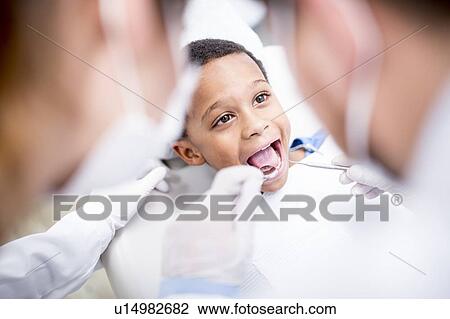 Stock Image - Boy having oral check-up. Fotosearch