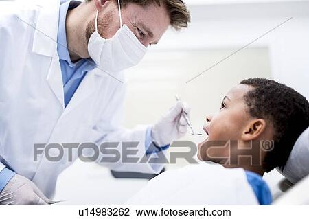 Boy having oral check-up View Large Photo Image Stock Image - Boy having oral check-up. Fotosearch