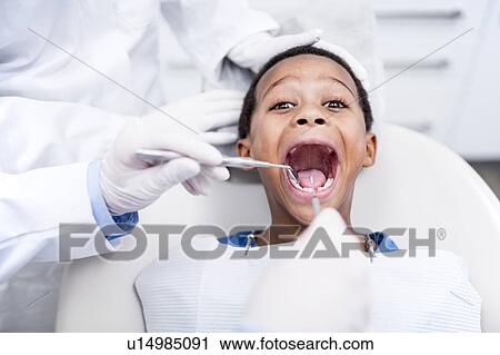 Stock Image - Boy having oral check-up. Fotosearch