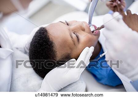 Boy having oral check-up View Large Photo Image Stock Photo - Boy having oral check-up. Fotosearch