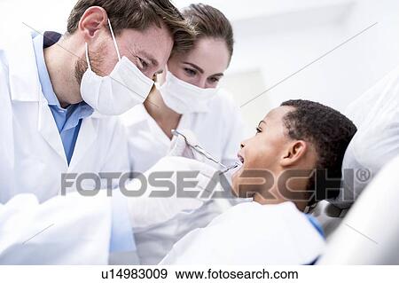 Stock Photo - Boy having oral check-up. Fotosearch