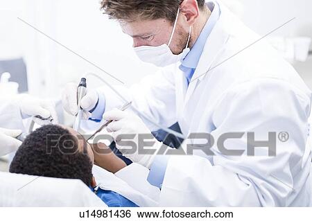 Boy having oral check-up View Large Photo Image Stock Photograph - Boy having oral check-up. Fotosearch