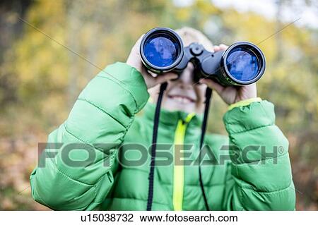Stock Image - Boy looking through binoculars. Fotosearch