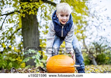 Boy with Halloween pumpkin View Large Photo Image Stock Photograph - Boy with Halloween pumpkin. Fotosearch