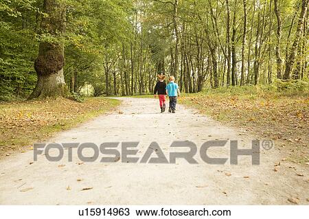 Stock Image - Children (2-3, 4-5) walking in park. Fotosearch