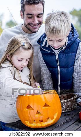 Children decorating Halloween pumpkin View Large Photo Image Stock Image - Children decorating Halloween pumpkin. Fotosearch