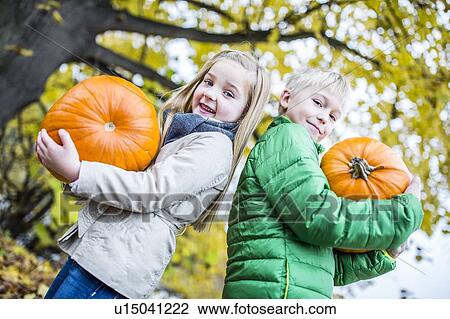 Children holding pumpkin View Large Photo Image Stock Image - Children holding pumpkin. Fotosearch