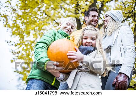 Children holding pumpkin View Large Photo Image Stock Photo - Children holding pumpkin. Fotosearch