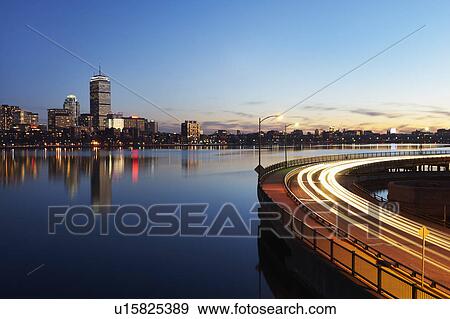 Stock Photo - City skyline with traffic at dusk. Fotosearch
