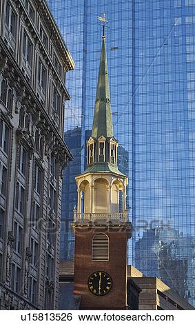 Clock tower against skyscraper in background View Large Photo Image Stock Photograph - Clock tower against skyscraper in background. Fotosearch