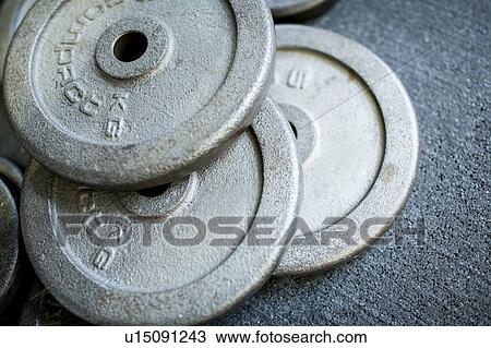 Stock Image - Close-up of weight plates in stack. Fotosearch