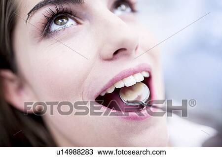 Close-up of woman while dental check-up View Large Photo Image Stock Image - Close-up of woman while dental check-up. Fotosearch