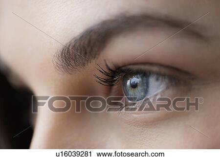 Stock Image - Close up of young woman with blue eyes. Fotosearch