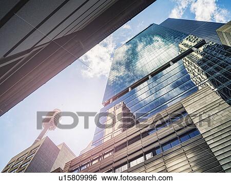Stock Photograph - Clouds reflecting in glass buildings. Fotosearch