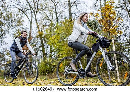 Stock Photo - Couple cycling together. Fotosearch