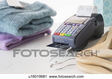 Stock Image - Credit card reader on counter. Fotosearch