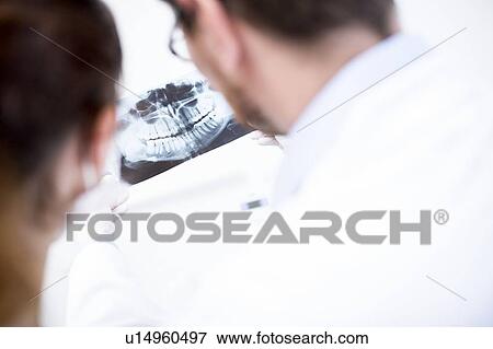 Dentist and assistant holding x-ray View Large Photo Image Stock Photo - Dentist and assistant holding x-ray. Fotosearch