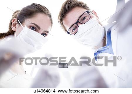 Picture - Dentist and dental assistant. Fotosearch