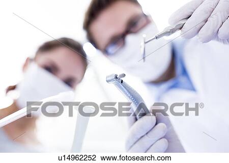Stock Image - Dentist and dental assistant. Fotosearch