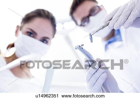 Stock Image - Dentist and dental assistant. Fotosearch