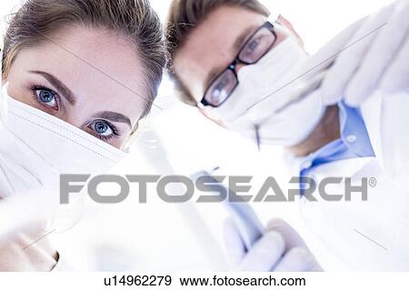 Stock Photo - Dentist and dental assistant. Fotosearch