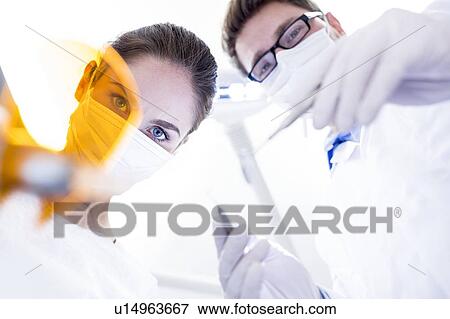 Stock Photo - Dentist and dental assistant. Fotosearch