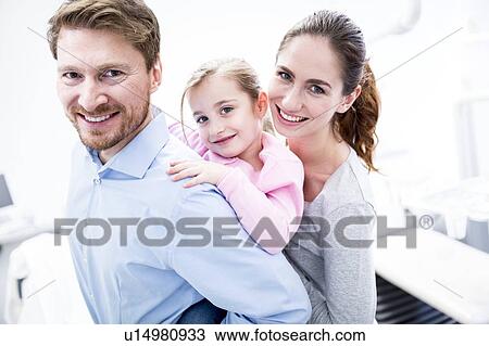 Stock Image - Dentist and dental assistant with girl. Fotosearch