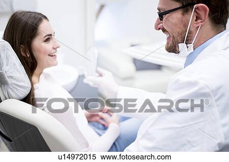 Dentist and patient smiling View Large Photo Image Stock Photography - Dentist and patient smiling. Fotosearch