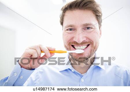 Dentist brushing teeth View Large Photo Image Picture - Dentist brushing teeth. Fotosearch