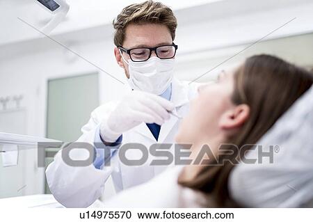 Dentist examining patient View Large Photo Image Stock Image - Dentist examining patient. Fotosearch