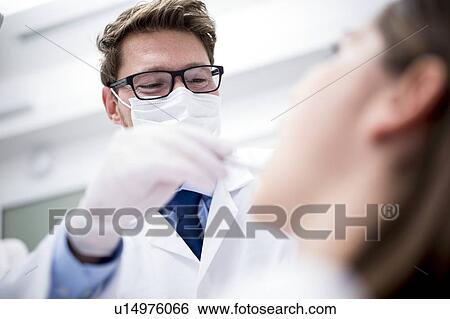 Dentist examining patient View Large Photo Image Stock Photograph - Dentist examining patient. Fotosearch