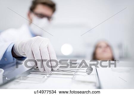 Dentist holding angled mirror View Large Photo Image Picture - Dentist holding angled mirror. Fotosearch