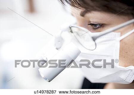 Stock Photo - Dentist with binocular. Fotosearch