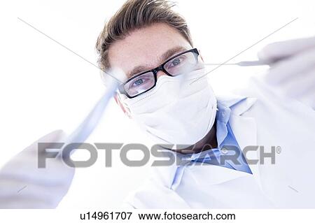 Stock Photo - Dentist with dental drill. Fotosearch