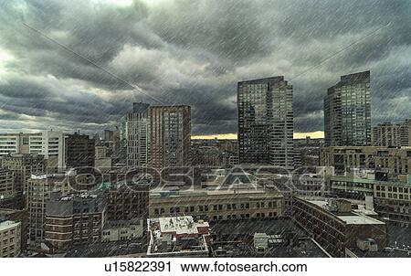 Stock Image - Downtown district on rainy day. Fotosearch