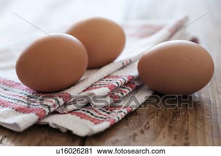 Stock Image - Eggs lying on tablecloth. Fotosearch