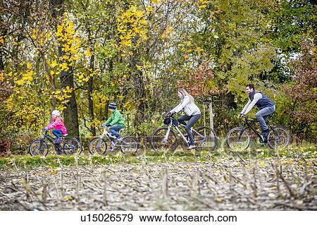Family cycling together View Large Photo Image Stock Photo - Family cycling together. Fotosearch