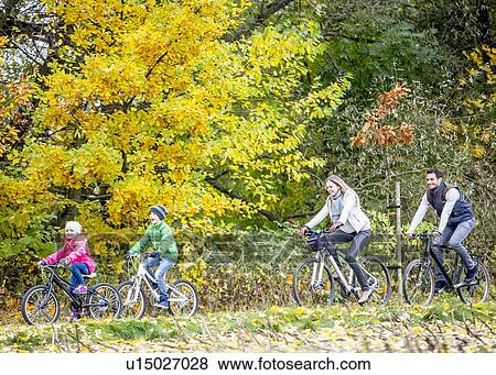 Stock Photo - Family cycling together. Fotosearch