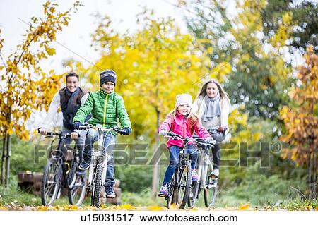 Stock Photo - Family cycling together. Fotosearch