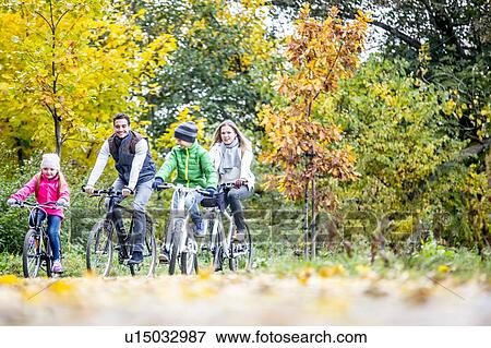 Stock Photo - Family cycling together. Fotosearch