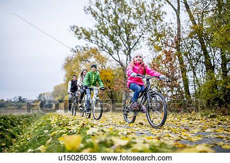 Stock Photography - Family cycling together. Fotosearch